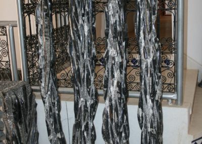 Black marble columns with nautiluses